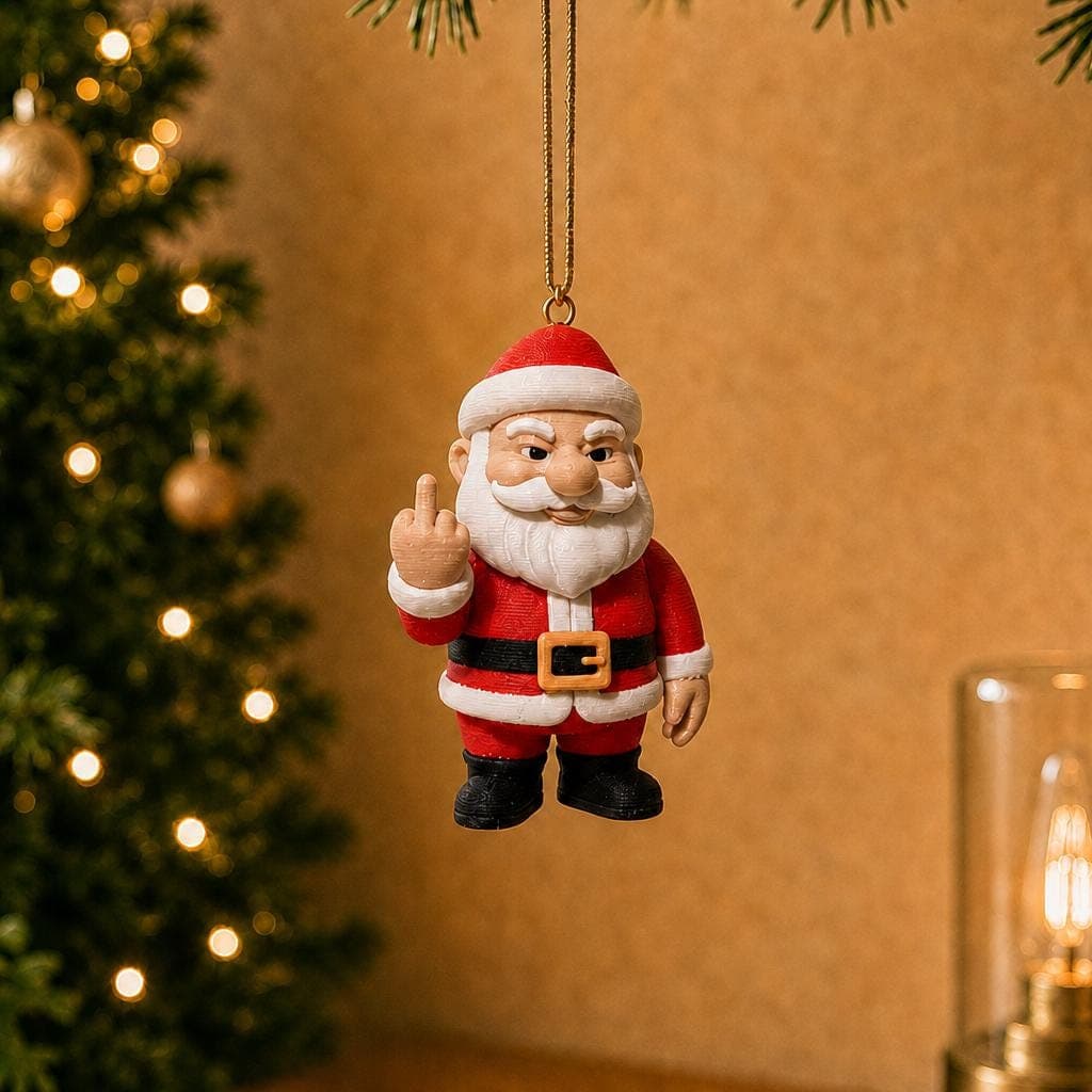 Funny Santa Claus ornament hanging beside a decorated Christmas tree and warm lamp, wearing a red suit and raising his middle finger.