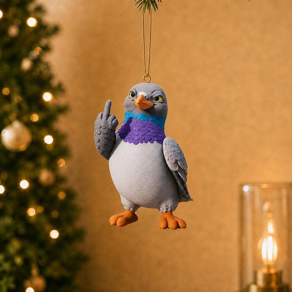 Funny blue hammerhead shark ornament hanging beside a decorated Christmas tree and warm lamp, with a white belly and raised middle finger.